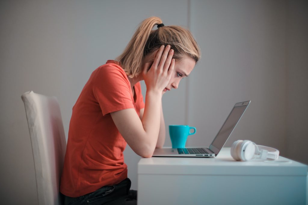 Female worker in front of computer, illustrating frustration with disposable software. 